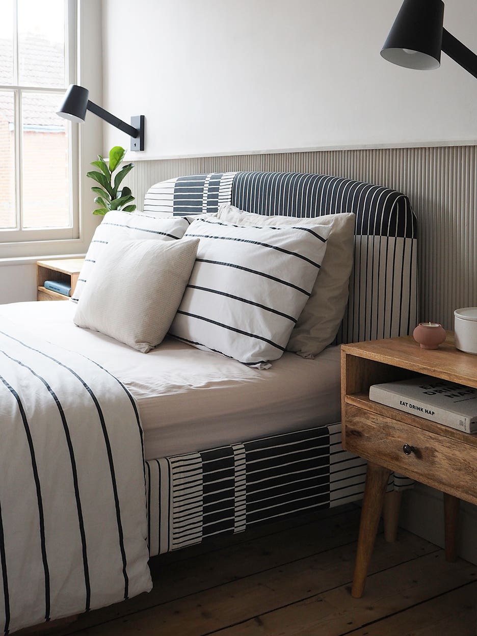 side view of striped upholstered bedframe with striped bedding