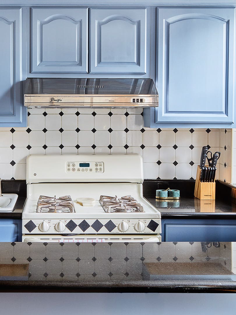 apartment kitchen with blue cabinets