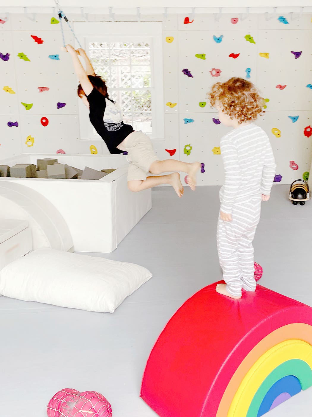 boy standing on foam rainbow