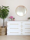 white dresser with brass detailing