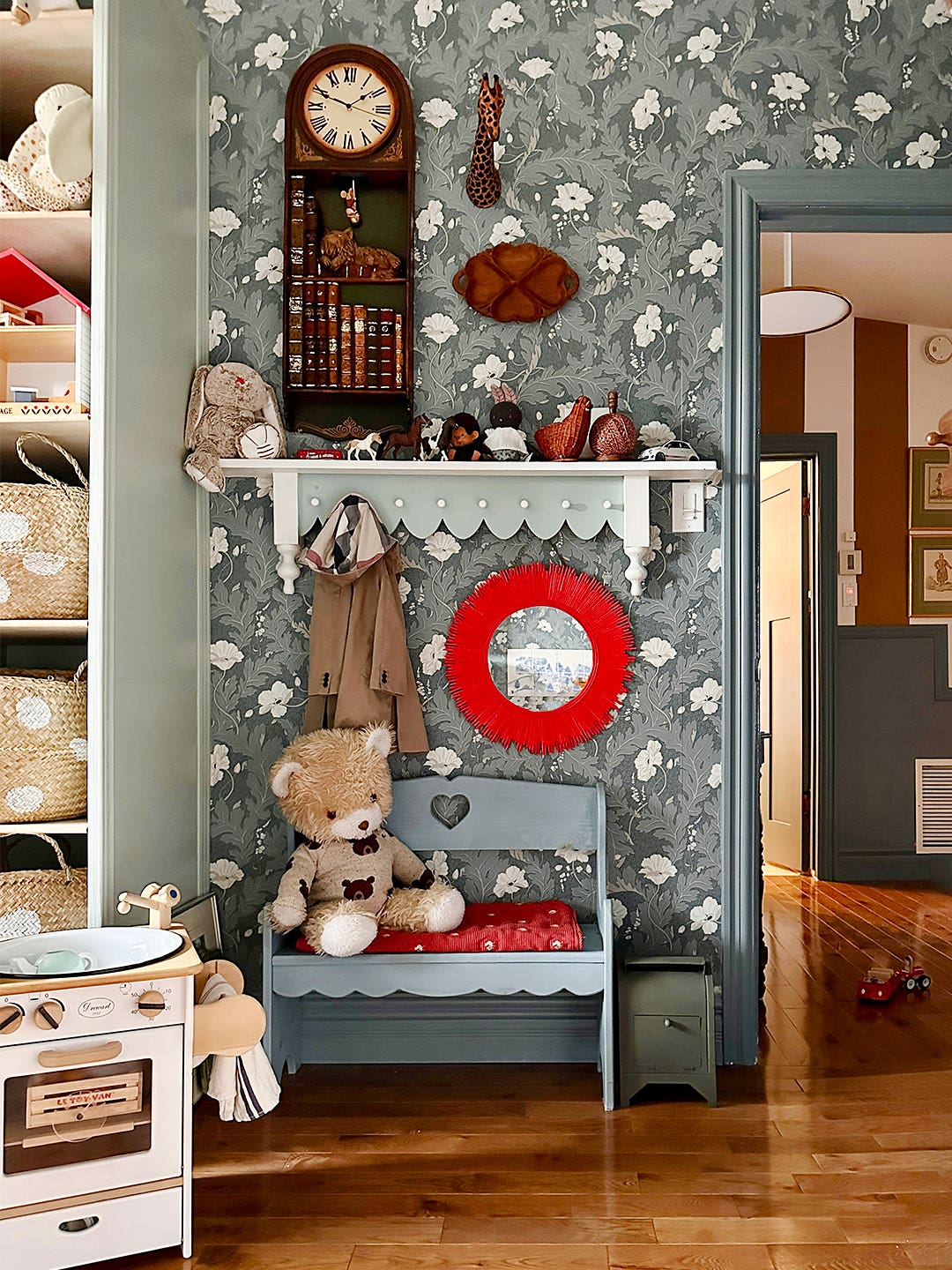 stuffed bear on bench in patterned kids' room