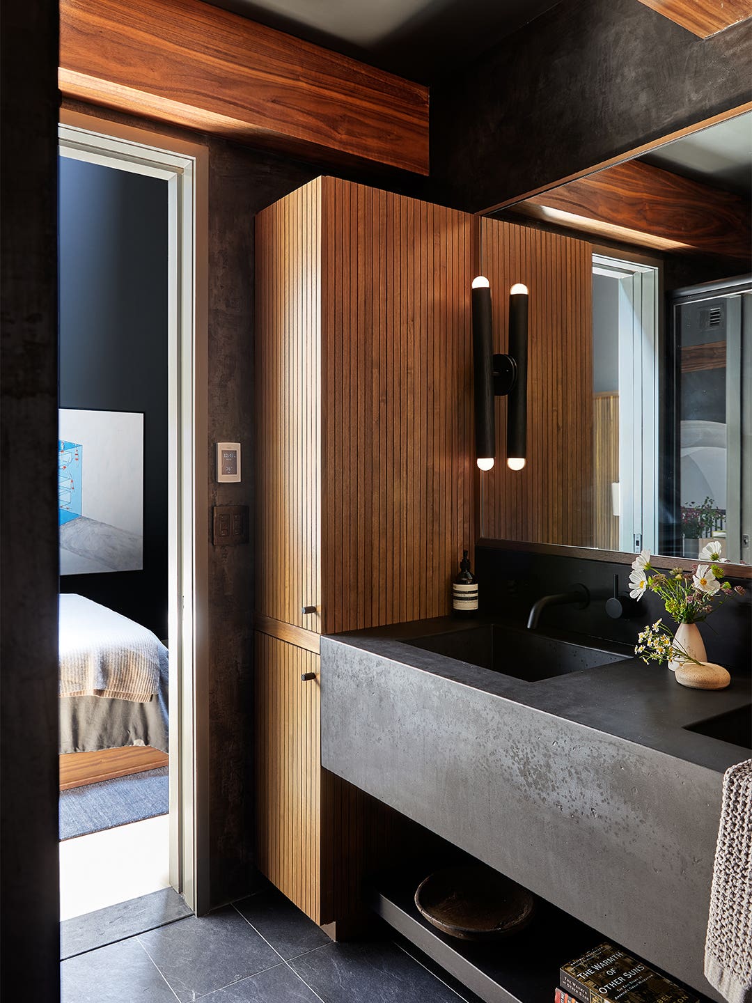 dark bathroom vanity with wood cabinet