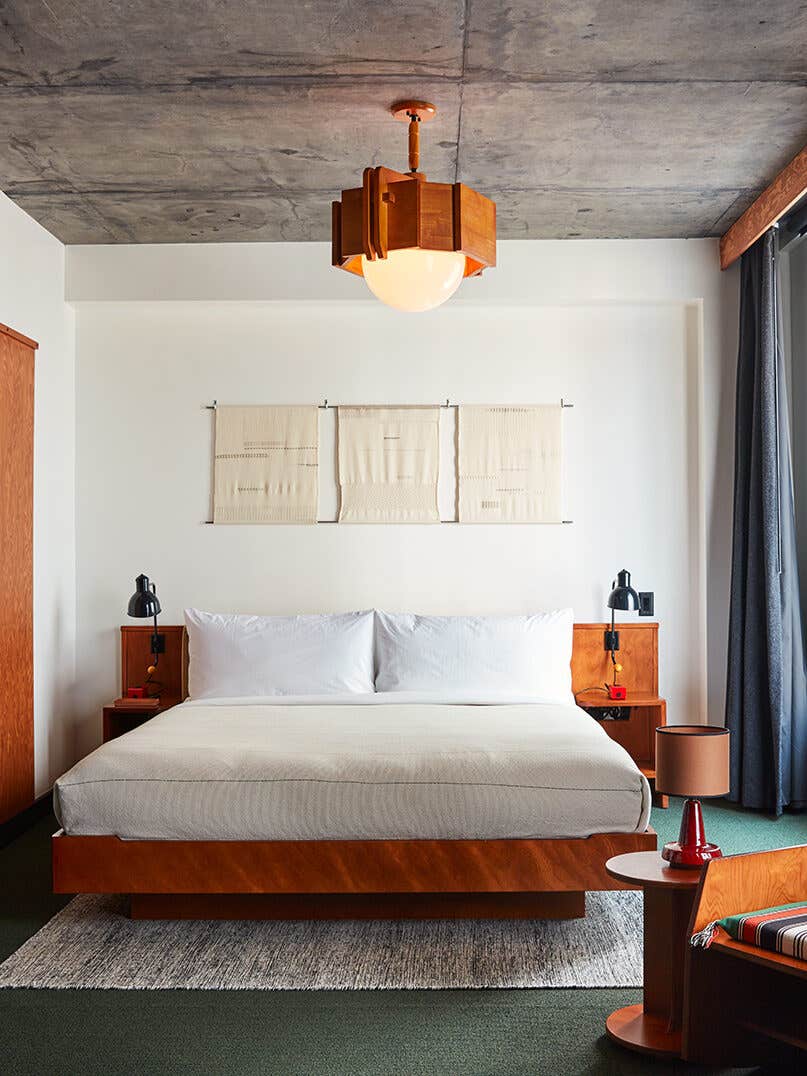 Hotel room with bed and wood lamp.