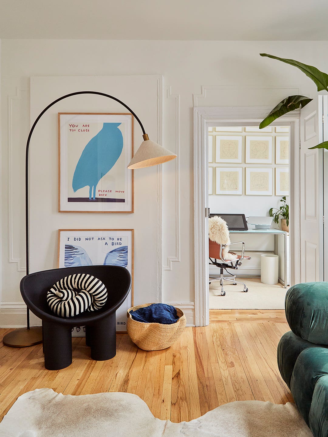 living room with black armchair and arch lamp