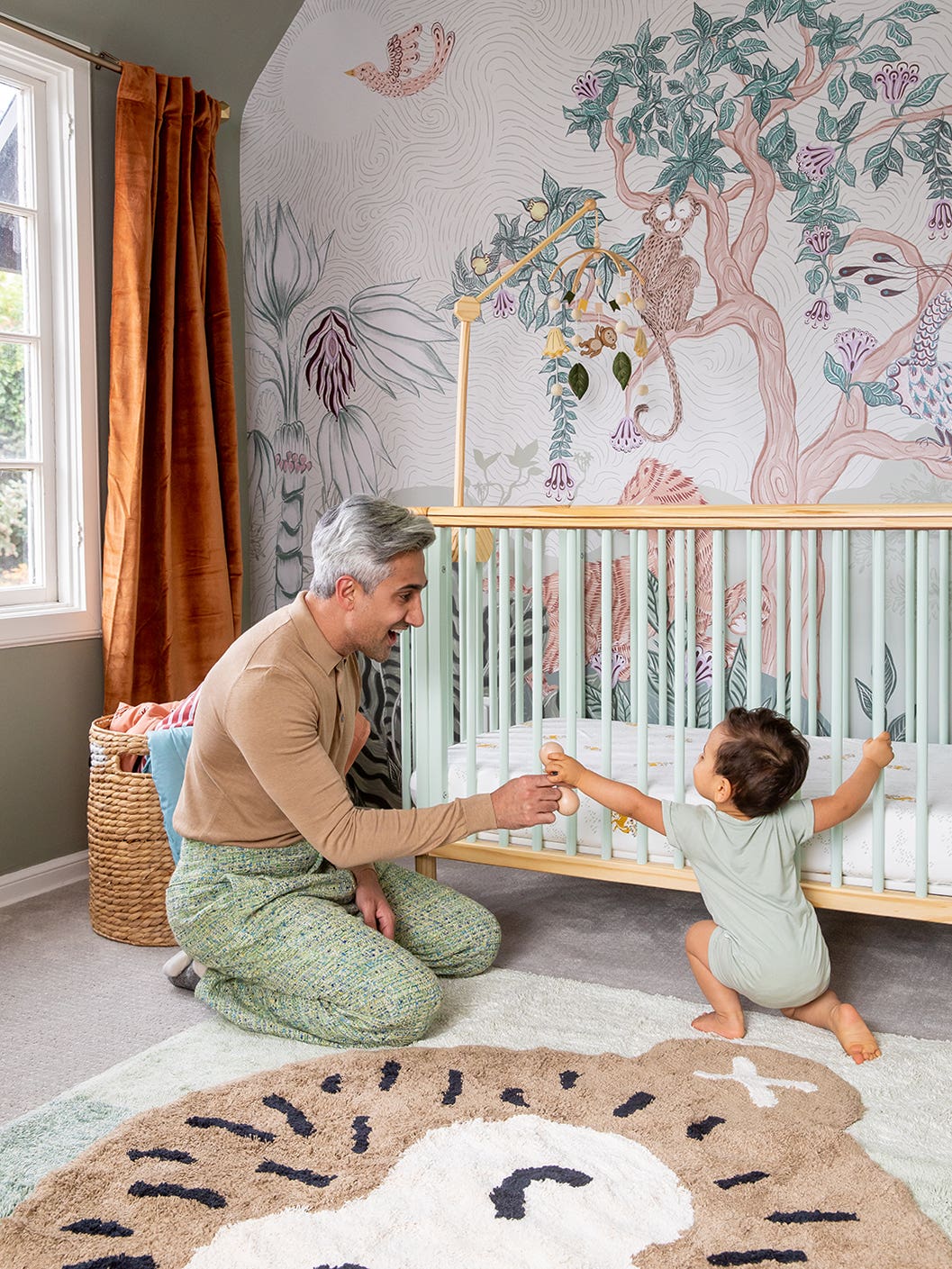 man playing with baby