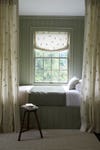 Sage green room with day bed and curtains.