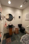 pedestal vanity and black toilet