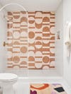 Shower wall with pink and ochre tiles