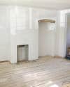 plastered room with exposed brick arch