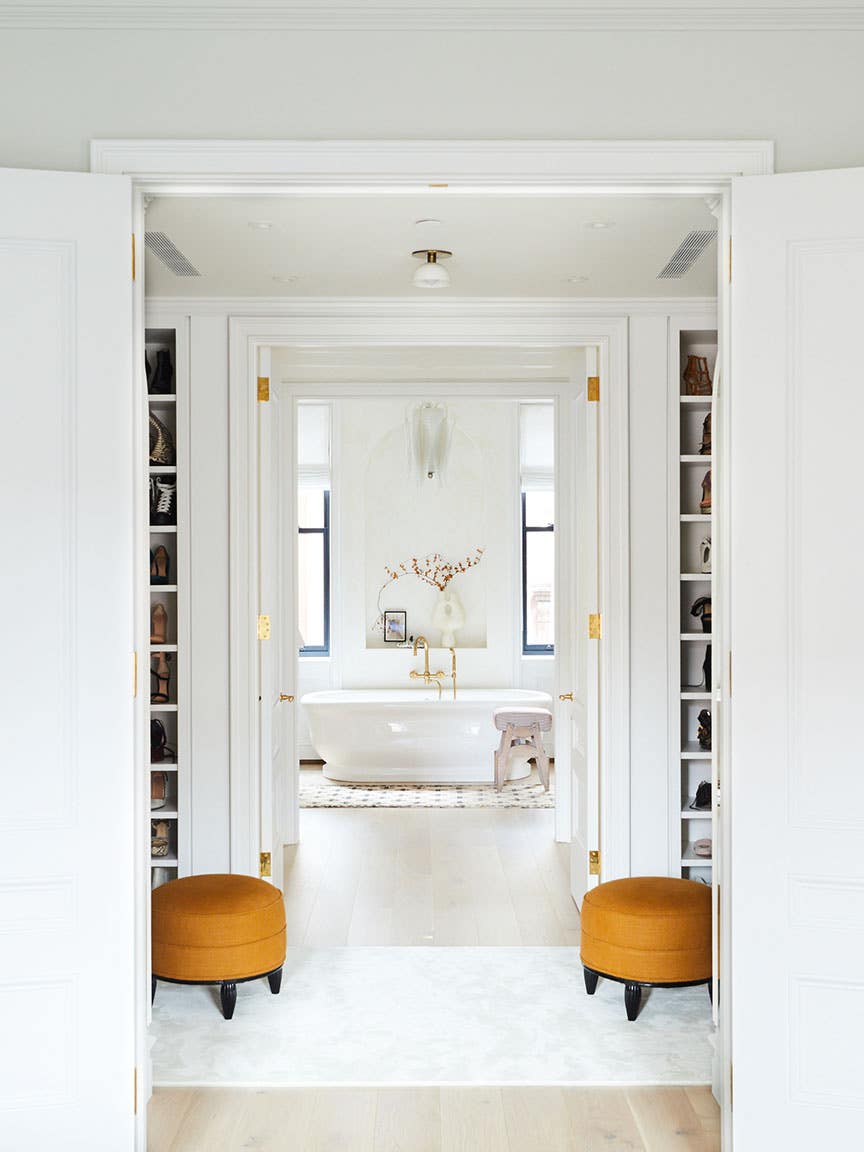 White bathroom at the end of the hallway