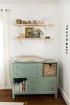 green changing table with cubbies