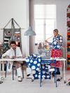 Man and woman in an office surrounded by fabrics