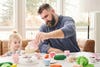 Dad pouring tea for his young daughter