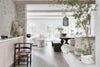 large wooden table with white plastered bench
