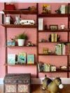 Kid's room detail of vintage teak wall-mounted bookshelves.