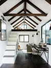Teen bunk house with lofted wood ceilings and white walls. 